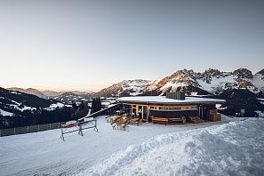 Außenansicht des Treichelhofes mit dem Wilden Kaiser im Hintergrund.