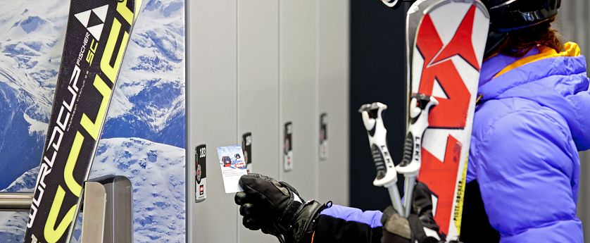 Skifahrerin öffnet Spin im Skidepot.
