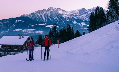 Freunde gehen bei Sonnenaufgang Skitouren.